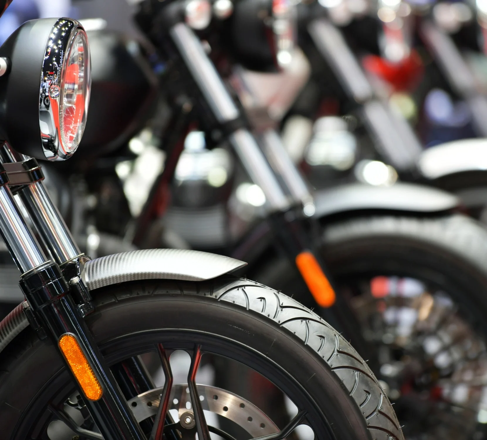 Motorbikes lined up in an showroom.