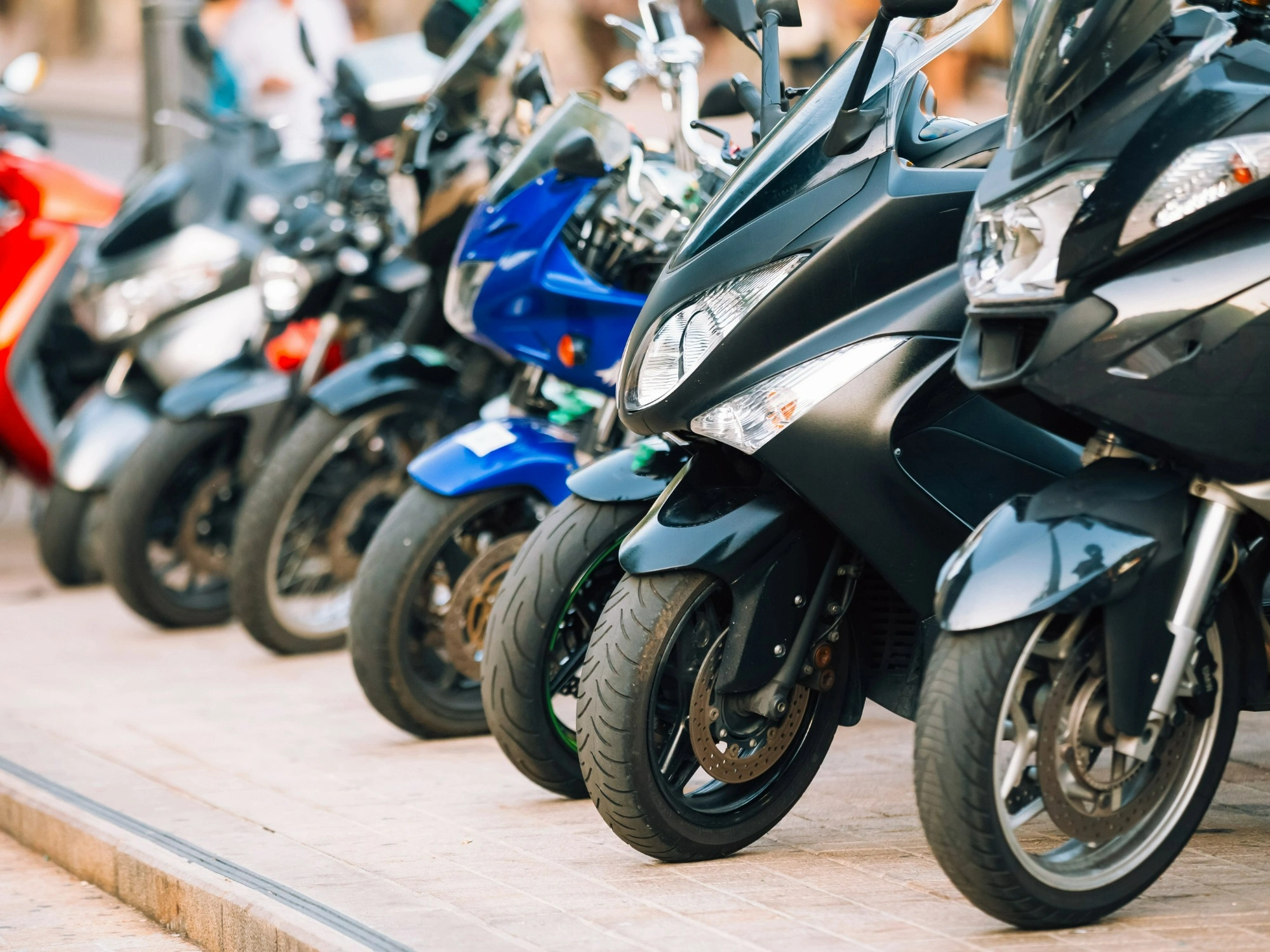 Motorcycles lined up on a pavement